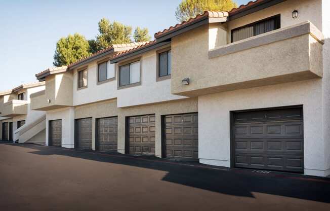 a row of houses with garage doors