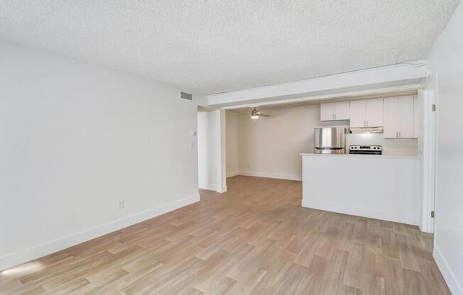 A room with a kitchenette in the middle of it.
