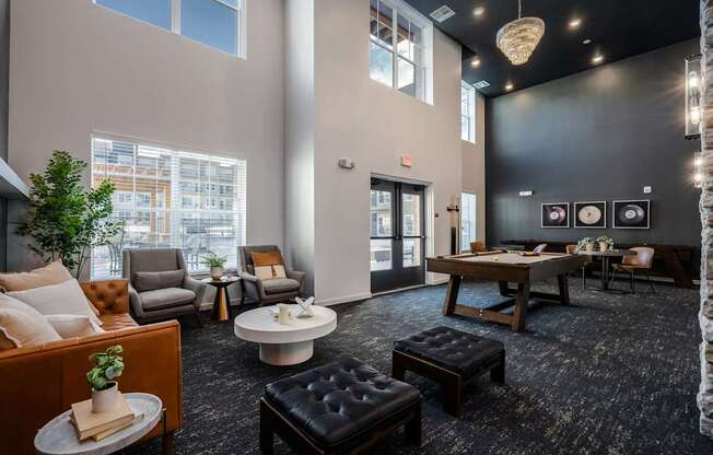 A living room with a black carpet and furniture.