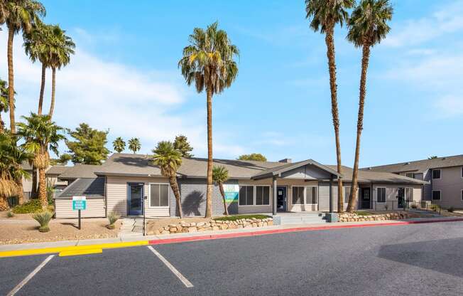 Clubhouse building with palm trees in front of it at 2900 Lux Apartment Homes, Nevada