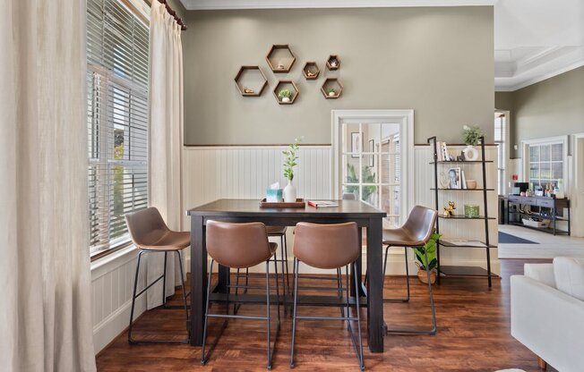 a dining room with a table and chairs