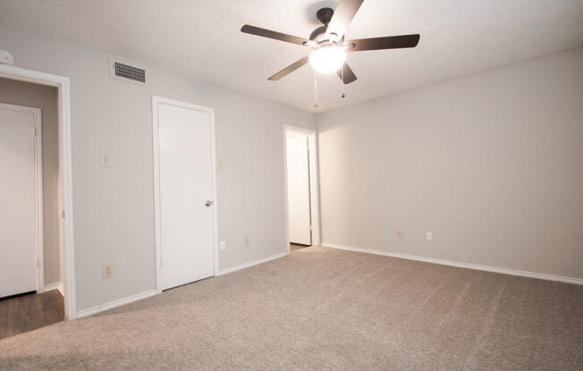 a empty room with a carpeted floor and a ceiling fan at The Broadwater at Salado Creek, Texas