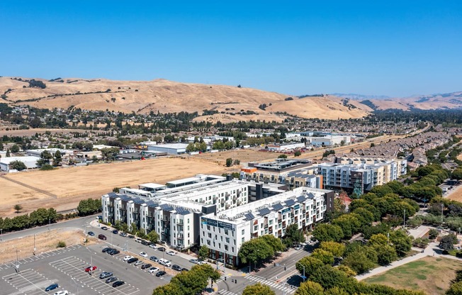 A large white building with a parking lot in front of it.
