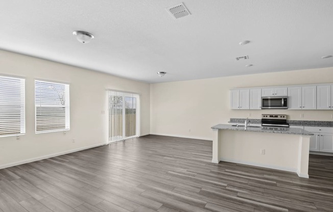 living room with big windows and white cabinets