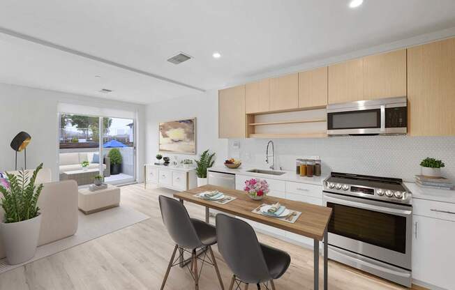 A modern kitchen with a dining table and chairs.
