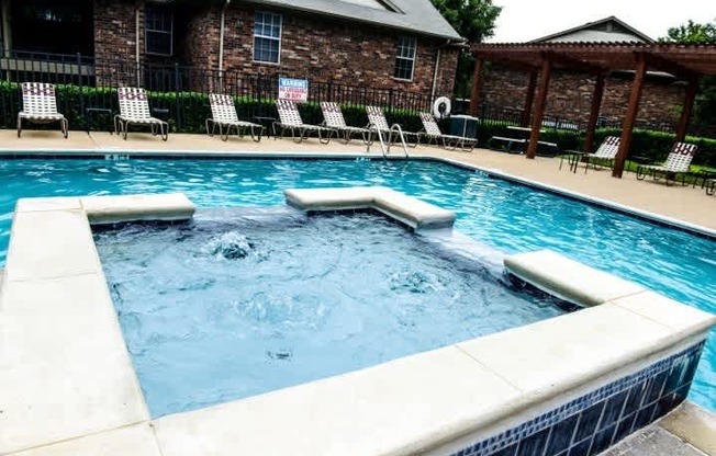 A pool with a blue tiled edge and a white coping.