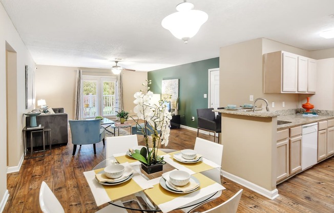 a kitchen and dining room with a table and chairs at Avalon Apartment Homes, Mississippi, 39759