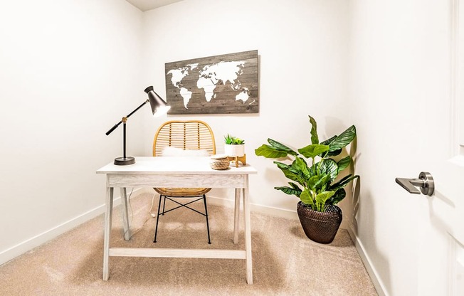 1 Bedroom Den space with desk and plant