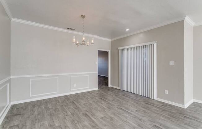 A room with a chandelier and a striped curtain.