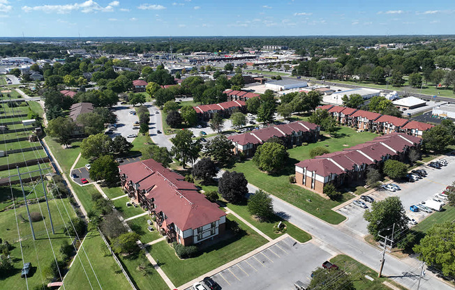 A bird's eye view of a park-like apartment community with a blue sky at Old Monterey Apartments, Springfield, MO