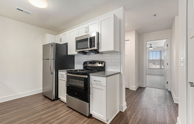 an empty kitchen with a stove and a refrigerator