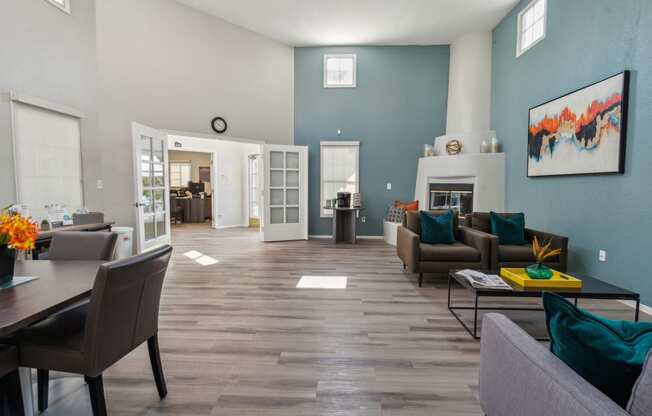 a living room and dining room with blue walls and a fireplace