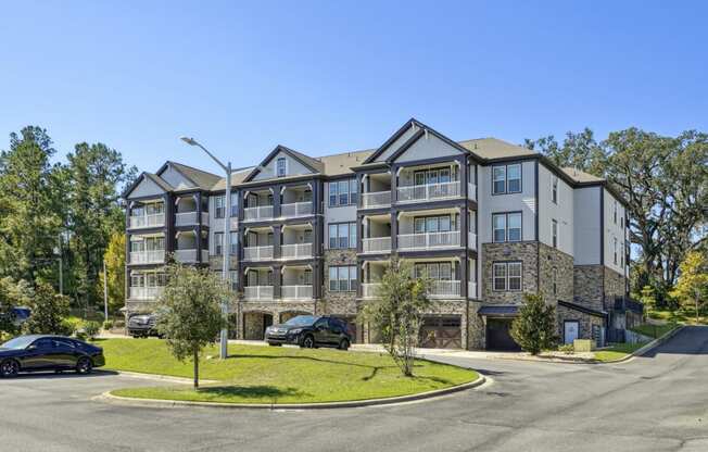 Our beautiful apartment buildings with lush landscaping along the roads at Evergreen at Southwood in Tallahassee, FL