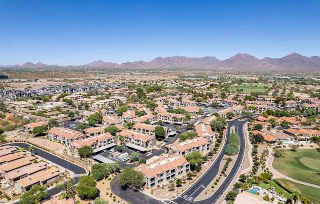 an aerial view of north scottsdale with houses and trees and mountains in the background