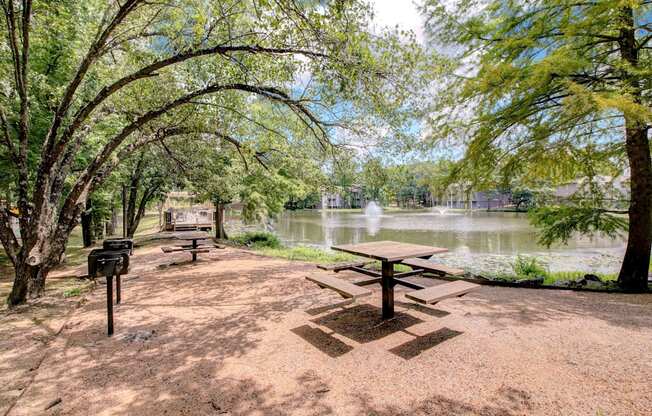 a picnic area with a picnic table next to a lake