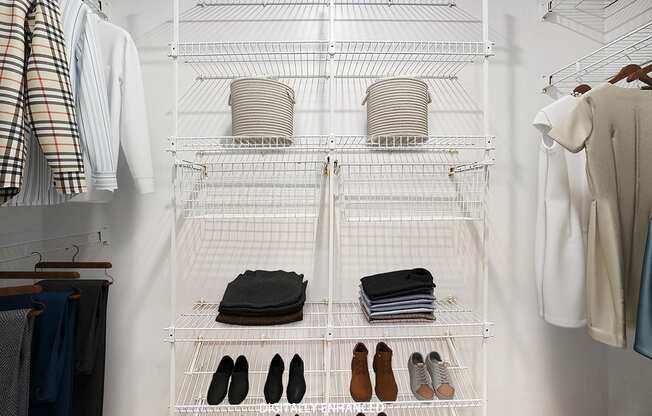 A walk in closet with wardrobe organizers at West Hampton Park Apartments in Elkhorn, NE 68022