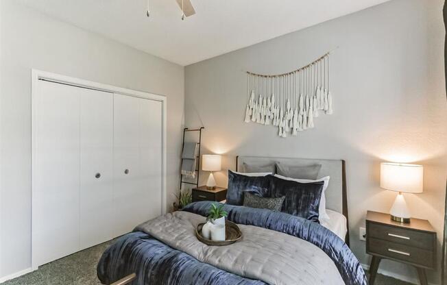 a bedroom with a bed and a ceiling fan