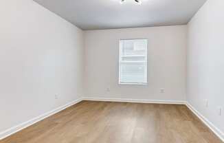 Whitney Manor Apartments in Gretna, LA photo of  bedroom with hardwood flooring and a window