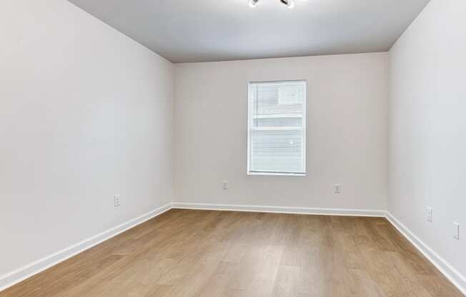 Whitney Manor Apartments in Gretna, LA photo of  bedroom with hardwood flooring and a window