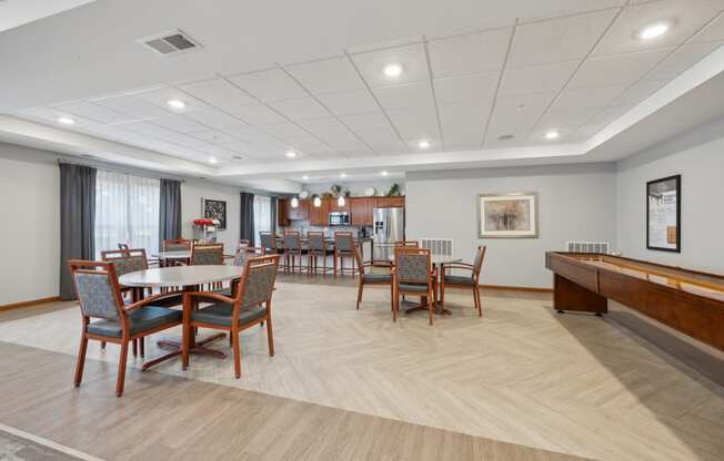 our resident dining room with tables and chairs and a piano