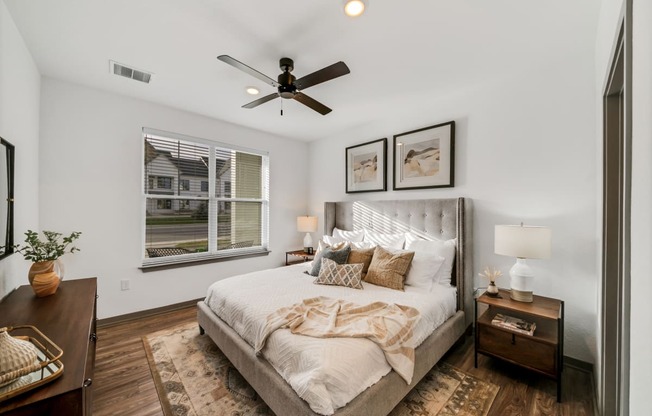 a bedroom with a large bed and a ceiling fan at The BLVD at Wilson Crossings, Wyoming