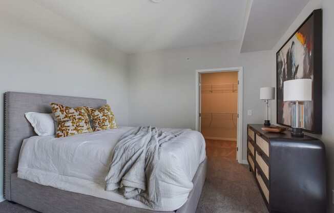 a bedroom with a bed and a dresser