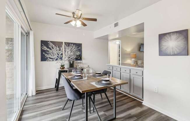 a dining room with a table and a ceiling fan