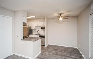 Living room and kitchen with a ceiling fan  at Avery Park in Englewood, CO