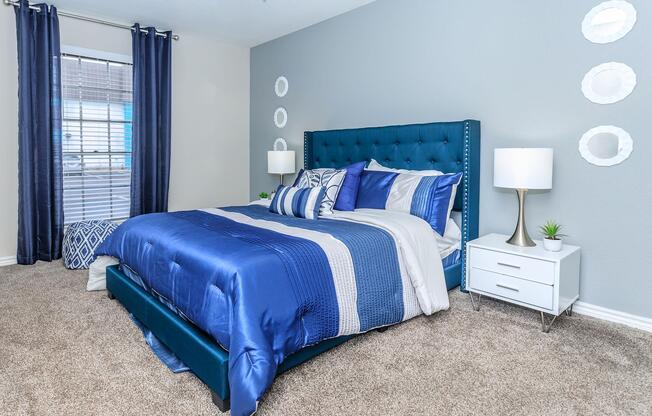 a bedroom with a blue bed in a room