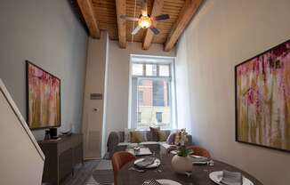 a living room with a dining room table and a ceiling fan at Lowertown Commons Apartments, St. Paul, MN, 55101