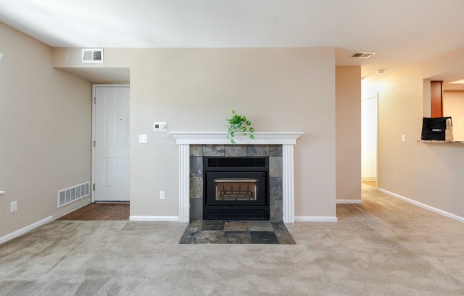 a living room with a fireplace and a carpeted floor