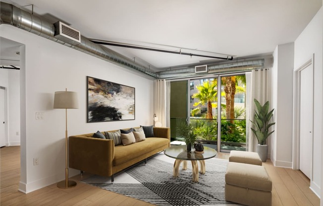 a living room with a couch and a coffee table and a large window