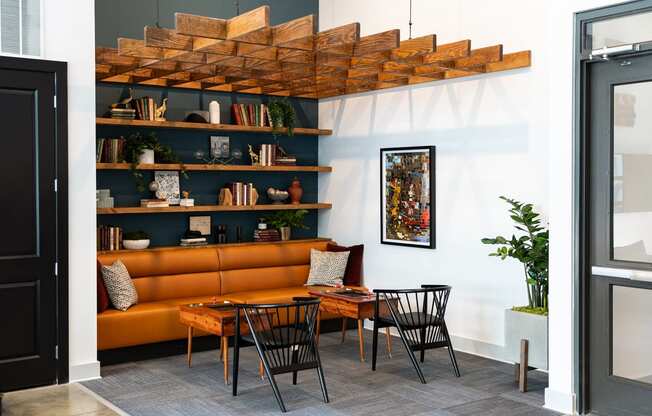 a living room with a brown couch and a table and chairs