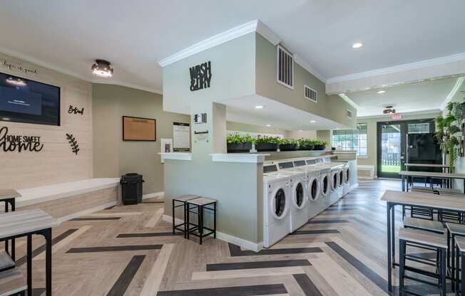 fusion fort worth laundry room with many laundry machines and large waiting area