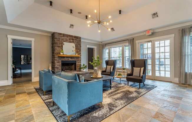 a living room with couches and chairs and a fireplace at Reserve by the Lake, Houston, TX, 77084