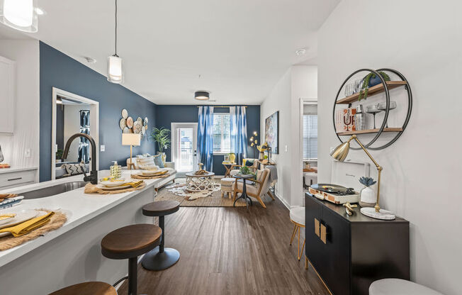 a living room with a bar and a dining room