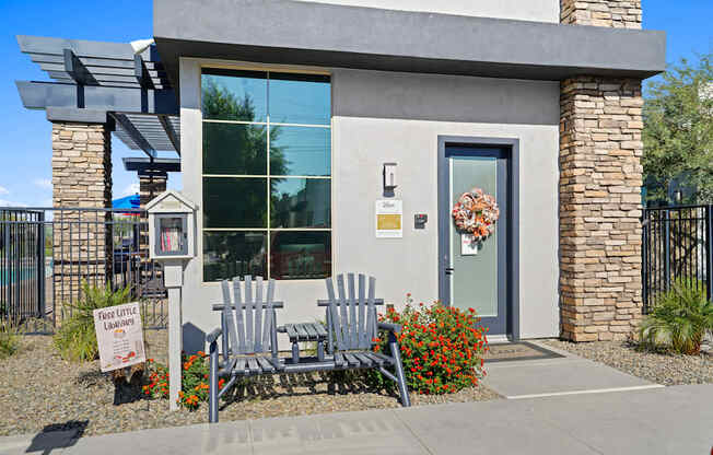 a building with two wooden rocking chairs in front of it