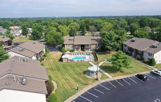 an aerial view of a neighborhood with houses and a swimming pool