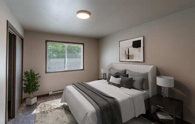 a bedroom with a large bed and a window. Fargo, ND Granger Court Apartments