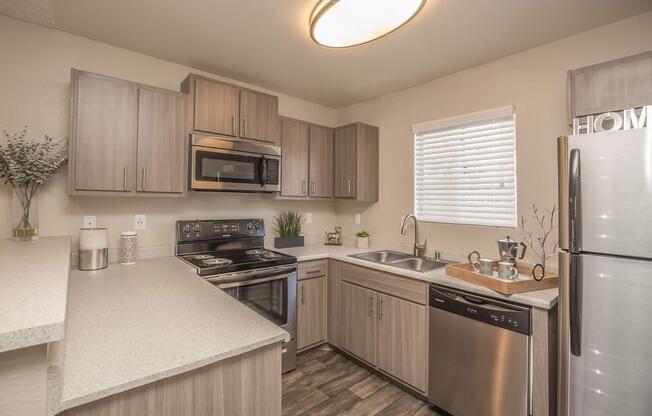 a kitchen with stainless steel appliances and wooden cabinets