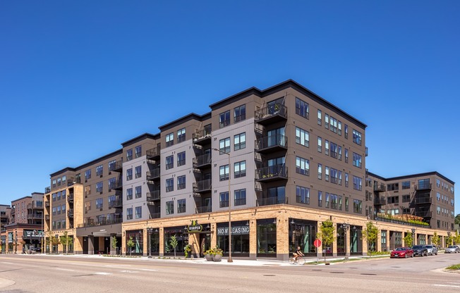 a large apartment building with a street in front of it
