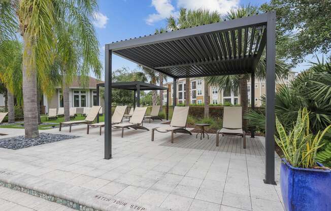 a covered patio with chairs and a pergola