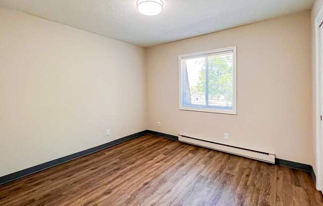 A room with a window and a white door at The Hampton Meadows Apartments,Des Moines, Iowa