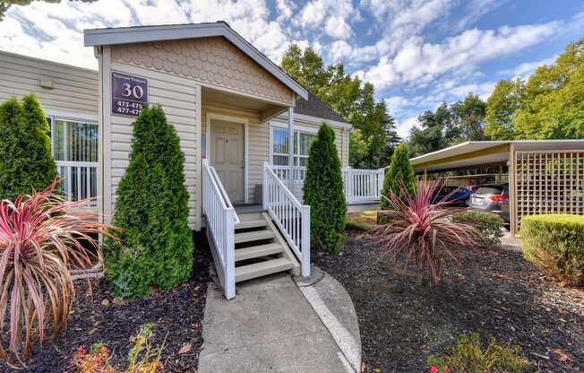 Apartment entrance with small staircase leading up to the front of the building.  