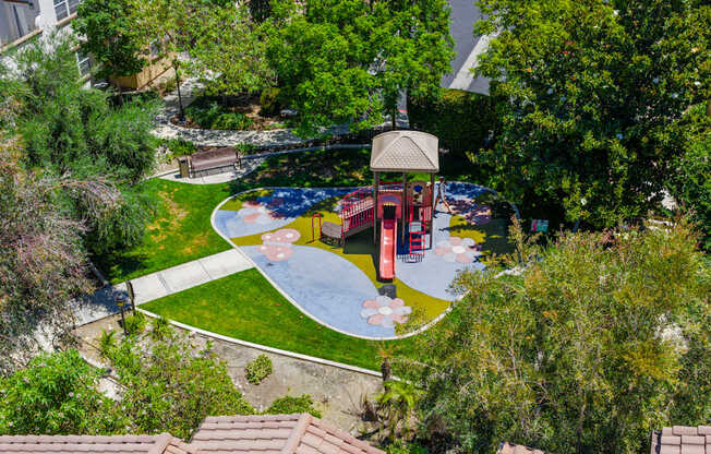A playground with a slide and a gazebo.