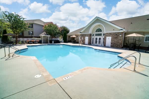 A swimming pool with a building in the background.