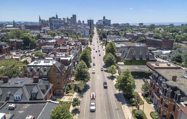 an aerial view of a city street with cars and buildings at The Knights @ 506 Delaware Apartments, Buffalo