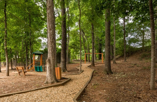 View of Walking Path, Showing Playground and Trees at Retreat at Peachtree City Apartments