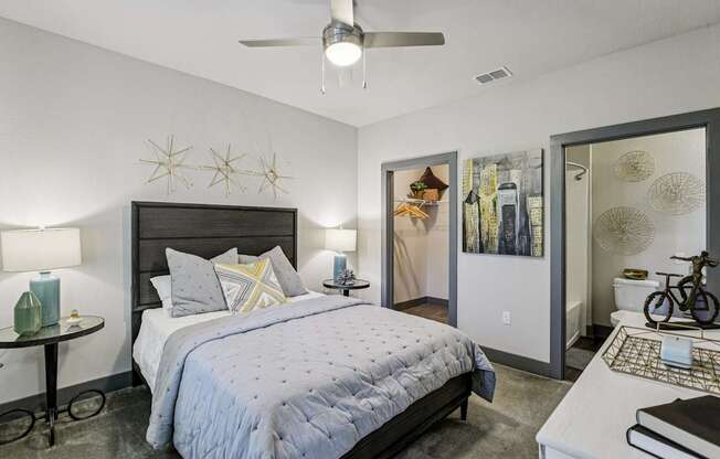 Bright bedroom with large windows, ceiling fan, and simple decor at Lotus at Starkey Ranch in Odessa, Florida.