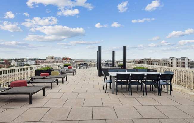 a terrace with tables and chairs on top of a roof